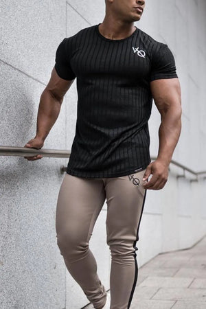 Black ribbed tee with vertical texture and logo detail, short sleeves, crew neck.