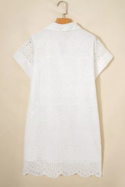 White cotton eyelet embroidered mini dress with short sleeves and a collared neckline.