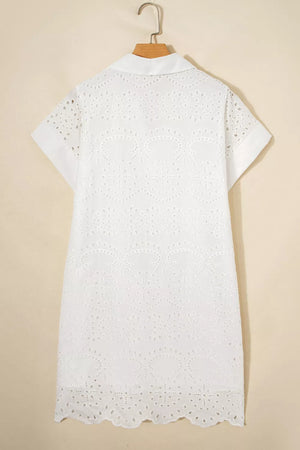White cotton eyelet embroidered mini dress with short sleeves and a collared neckline.