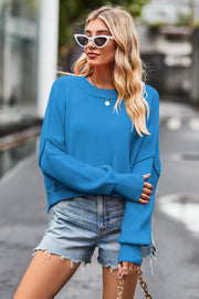 Sky blue ribbed knit batwing sweater with crew neck and cropped length.