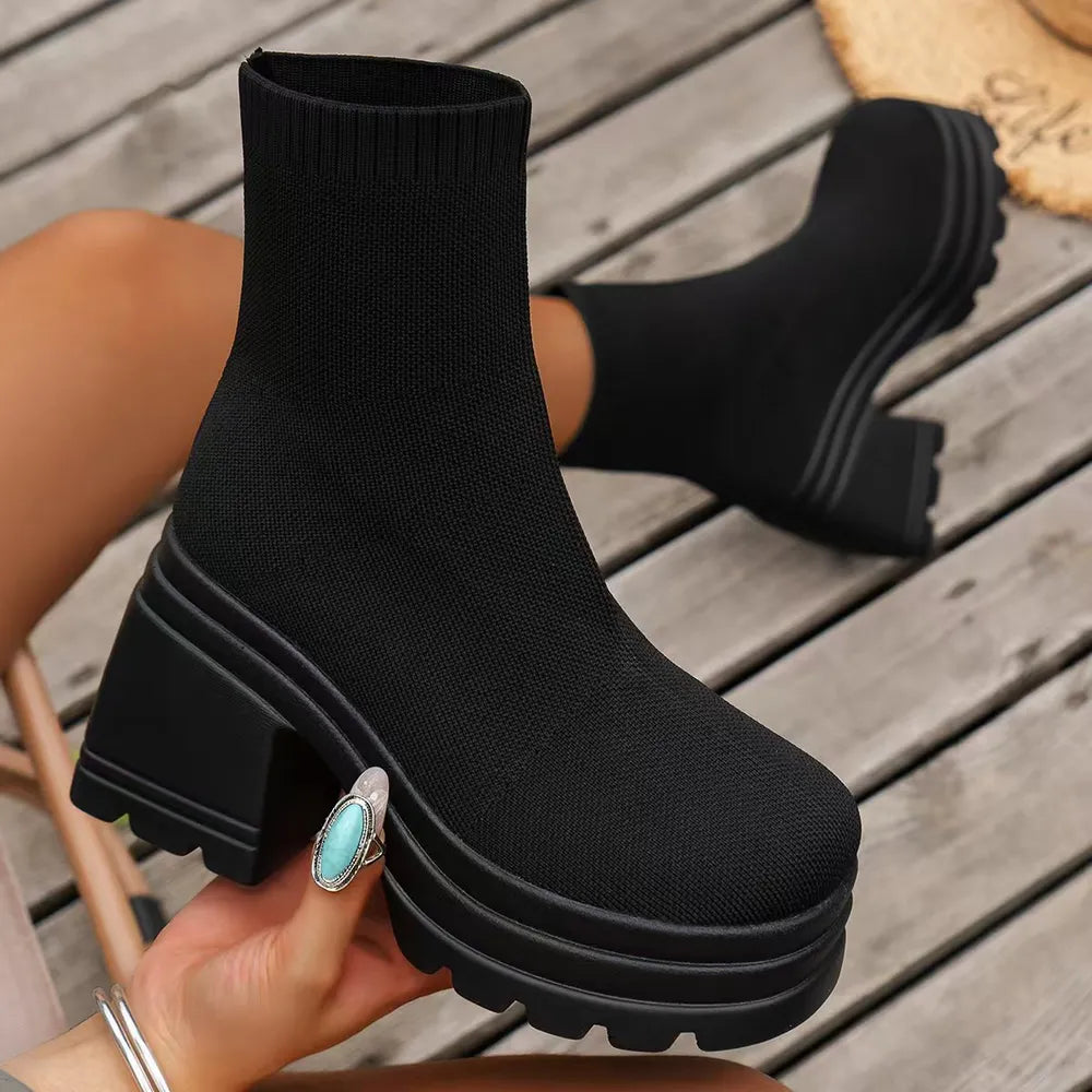 Black knit sock boots with chunky platform and block heel.