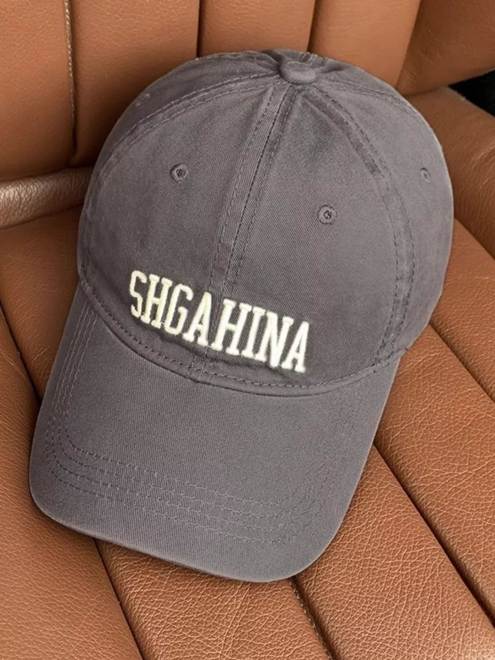 Grey cotton baseball cap with mirrored letter embroidery and curved brim.