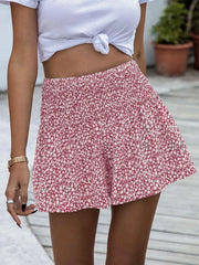 Red floral chino shorts with elastic waist and a white knotted crop top.
