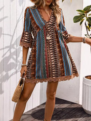 Bohemian printed v-neck dress with bell sleeves and lace trim, featuring a colorful pattern.
