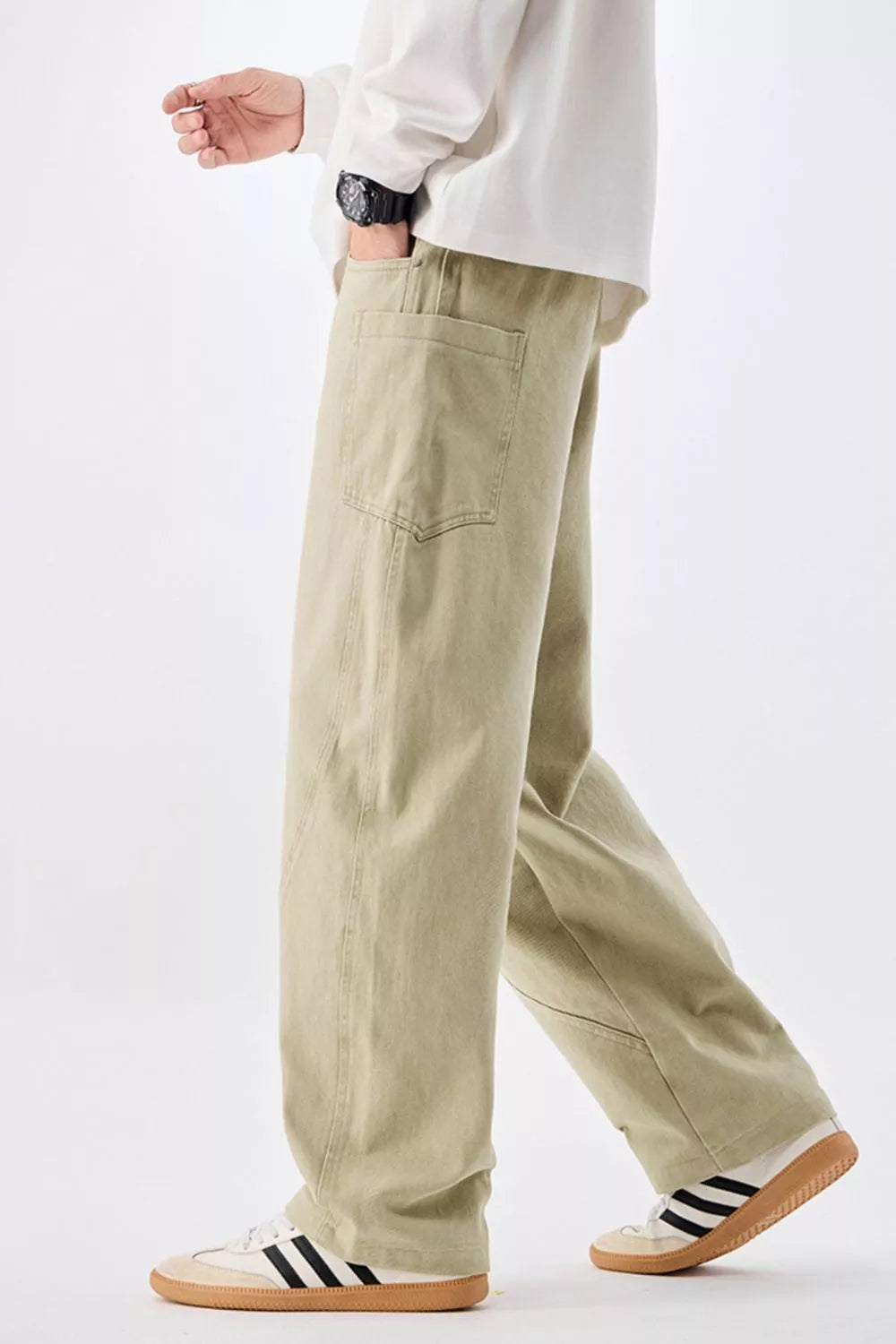 Men's relaxed fit sage cotton jeans with drawstring waist and back pocket detail.