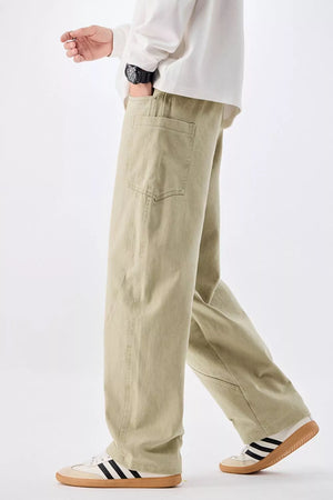 Men's relaxed fit sage cotton jeans with drawstring waist and back pocket detail.