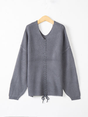 Dark Gray knit sweater with V-neck and lace-up detail at hem.