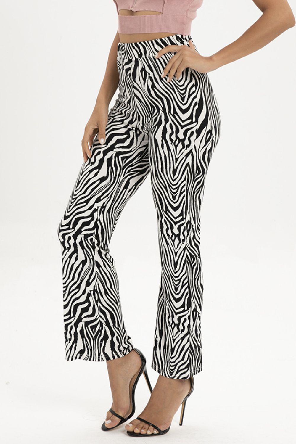 Zebra print flared leg trousers with a high waist, shown on a model.
