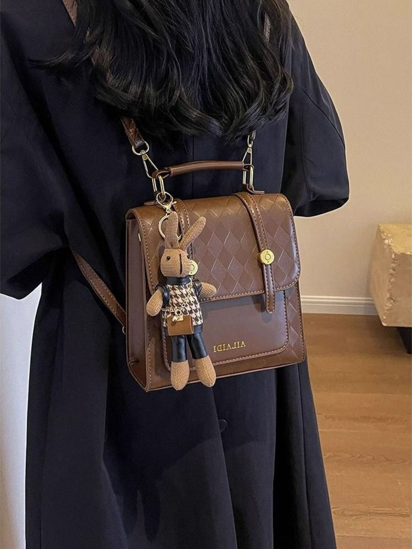 Brown quilted flap mini backpack with bunny charm