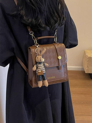 Brown quilted flap mini backpack with bunny charm