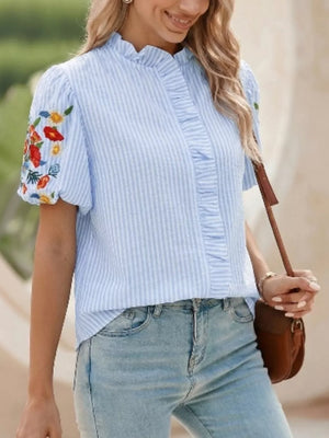 Blue striped cotton shirt with embroidered floral puff sleeves and ruffled front.