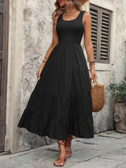Black smocked bodice tiered maxi dress with scoop neck and sleeveless design.
