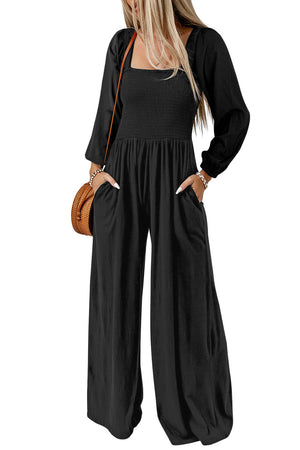 Black smocked bodice wide leg jumpsuit with square neckline and long sleeves.