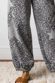 Leopard print wide-leg pants with grey star accents and elastic cuffs.