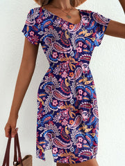 Vibrant paisley print mini dress with V-neck and short sleeves.