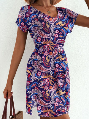 Vibrant paisley print mini dress with V-neck and short sleeves.