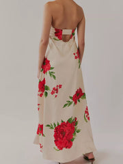 Ivory maxi dress with red floral print, gathered bodice, and open back detail.