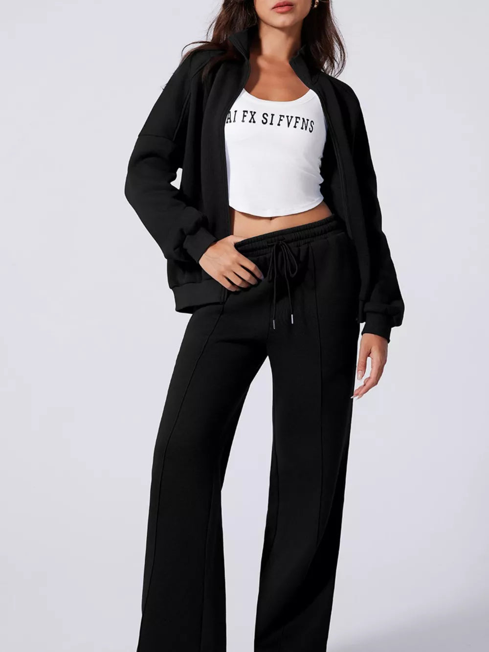 Black cotton joggers with drawstring waist and zip-up jacket.