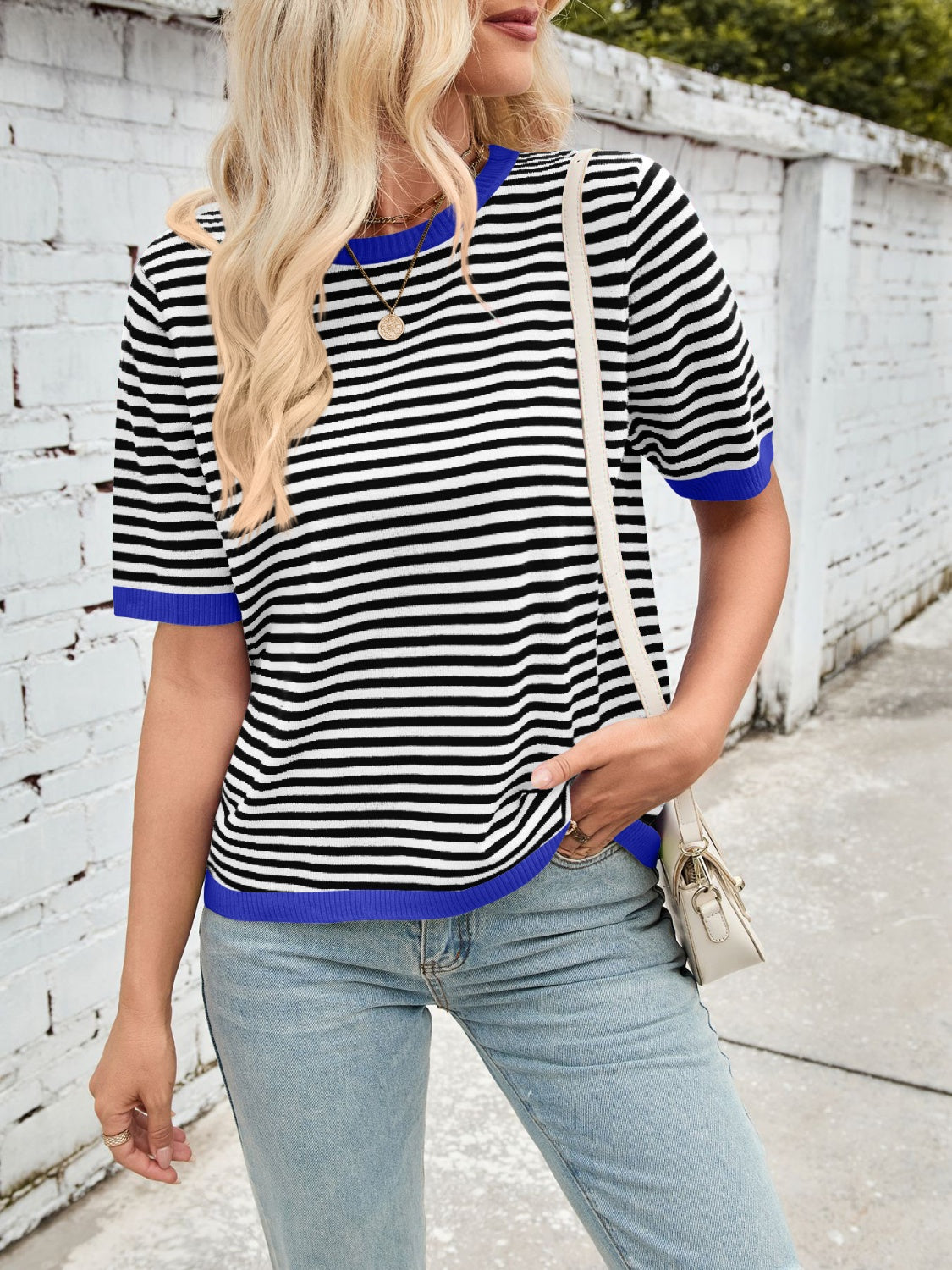 Striped knit tee with blue trim and short sleeves.