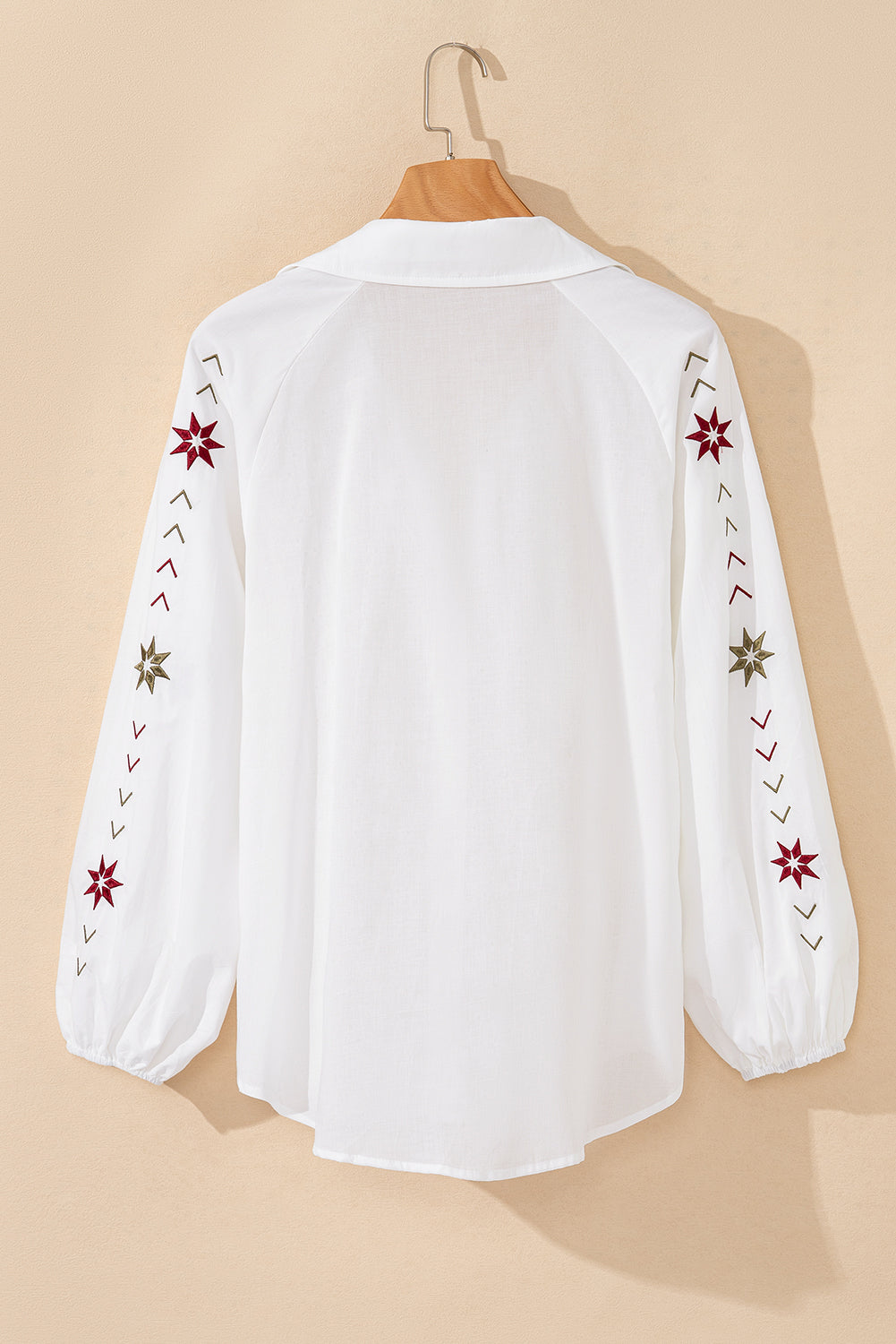 White embroidered eyelet blouse with poet sleeves and star detail