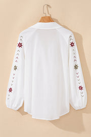 White embroidered eyelet blouse with poet sleeves and star detail