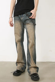 Faded wash bootcut denim jeans in medium with distressed detailing.