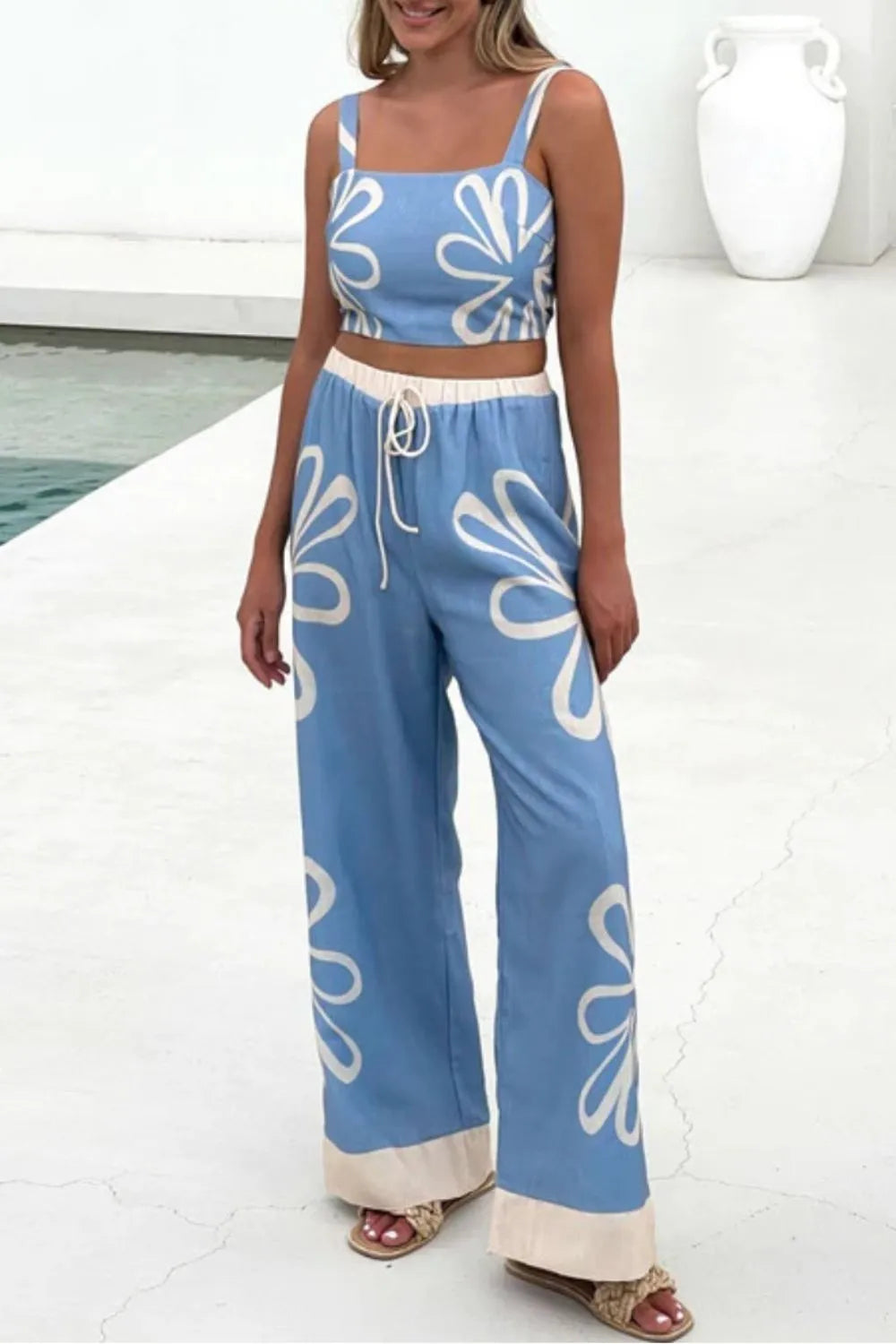 Light blue linen co-ord set with white floral print, crop top, and wide-leg pants.