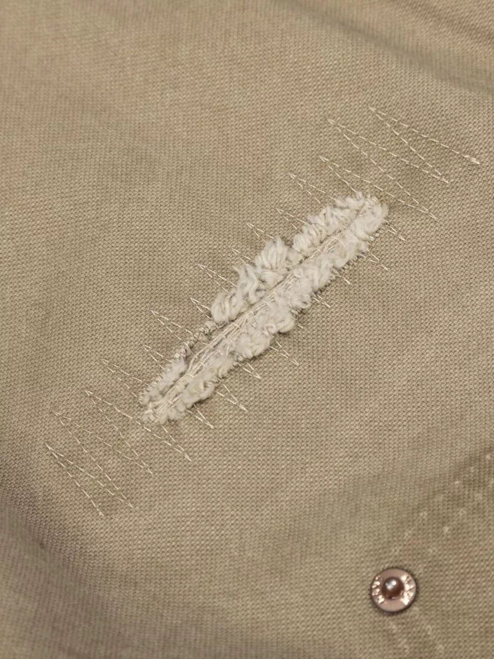 Khaki cargo pants with distressed detail and contrast stitching.
