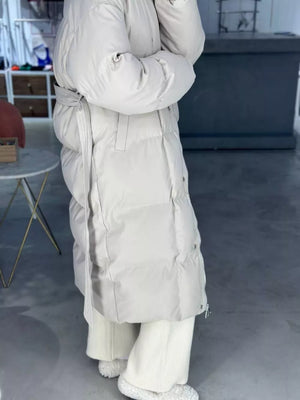 Ivory white padded trench coat with tie belt and button details.