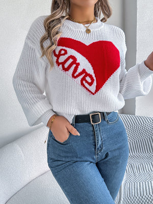 White knit sweater with red heart and "love" graphic, crew neck, long sleeves.