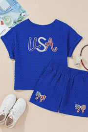 Royal blue textured USA tee and bow shorts set with American flag bow detail.