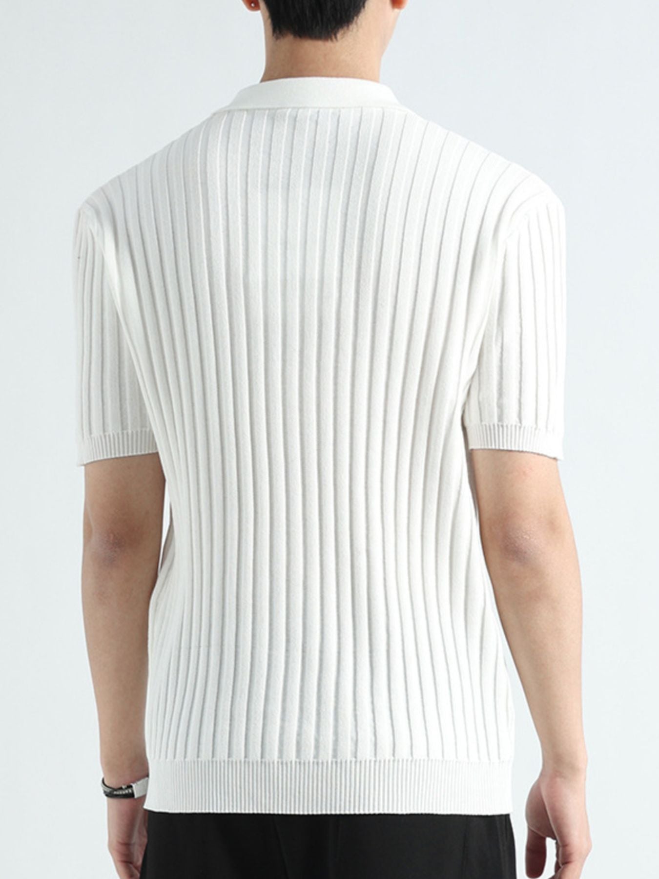 White ribbed knit polo shirt with short sleeves and a collar.