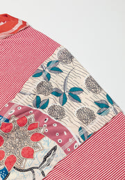 Patchwork tee with red stripes, floral print, and raglan sleeves.