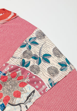 Patchwork tee with red stripes, floral print, and raglan sleeves.