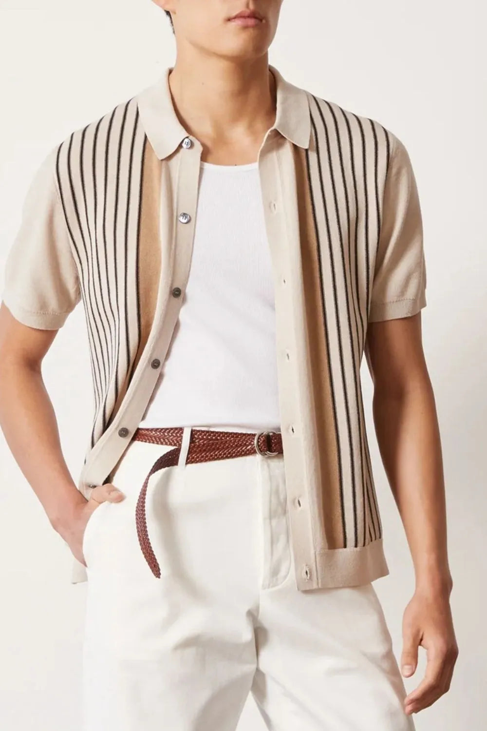 Beige knit polo shirt with vertical stripes and buttoned front, worn over a white tank top.
