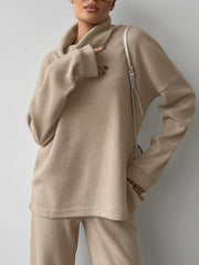 Beige cowl-neck turtleneck and pants set with relaxed fit and comfortable knit fabric.