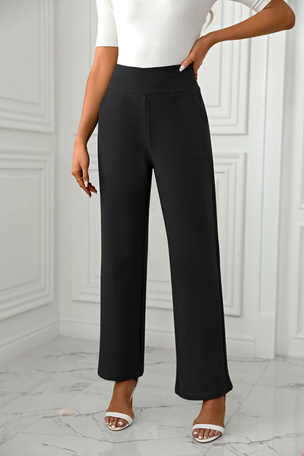 Black wide-leg trousers with a sculpted waist and a relaxed fit.