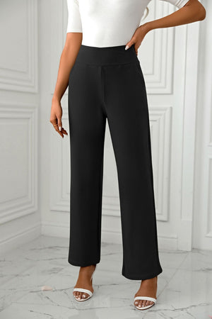 Black wide-leg trousers with a sculpted waist and a relaxed fit.