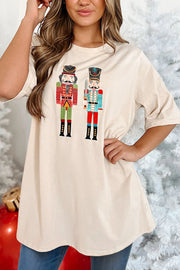 Tan oversized graphic tee with two nutcracker prints, crew neck, short sleeves.
