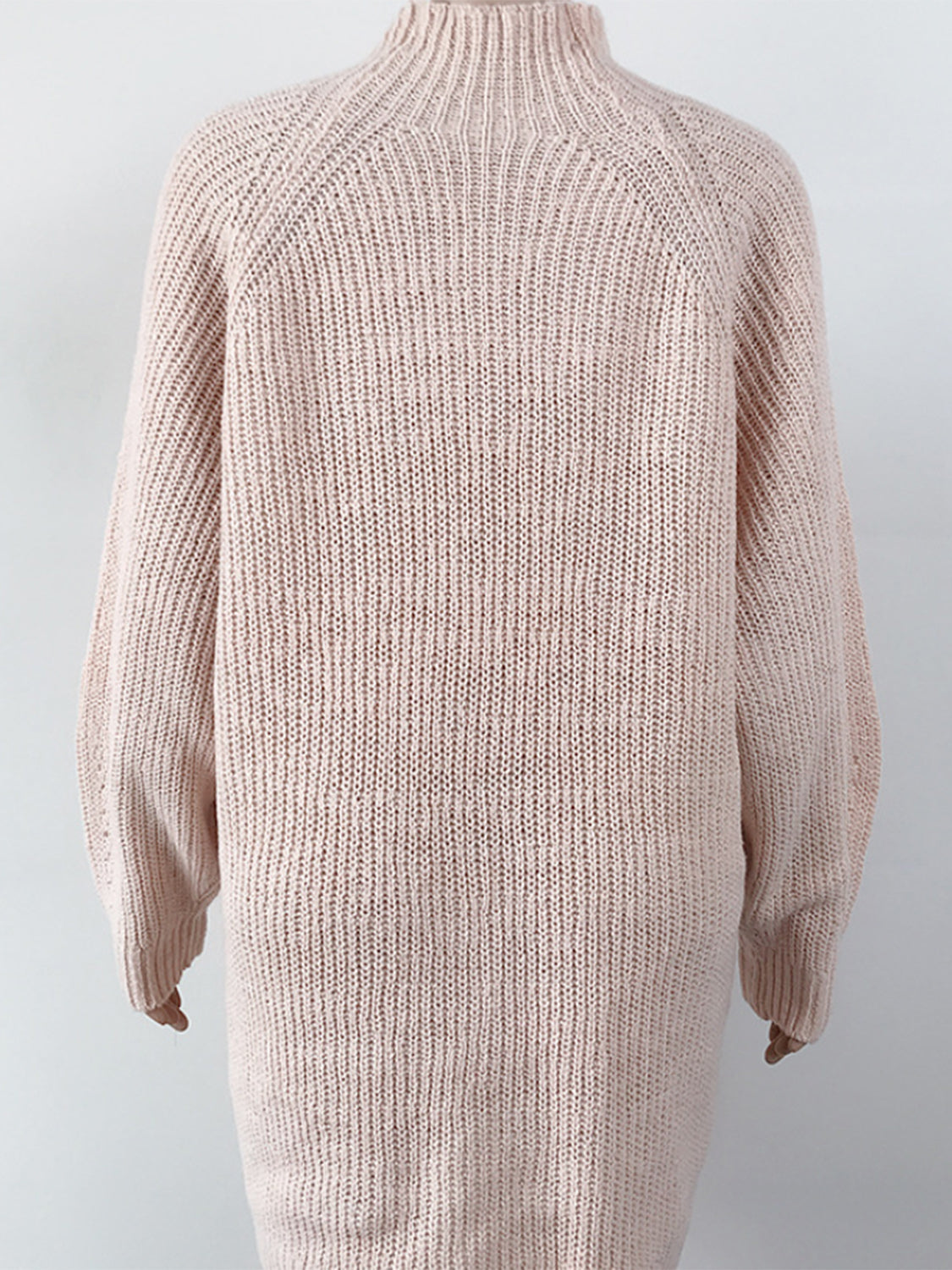Ribbed knit cocoon turtleneck dress in blush pink with long sleeves and a relaxed fit.