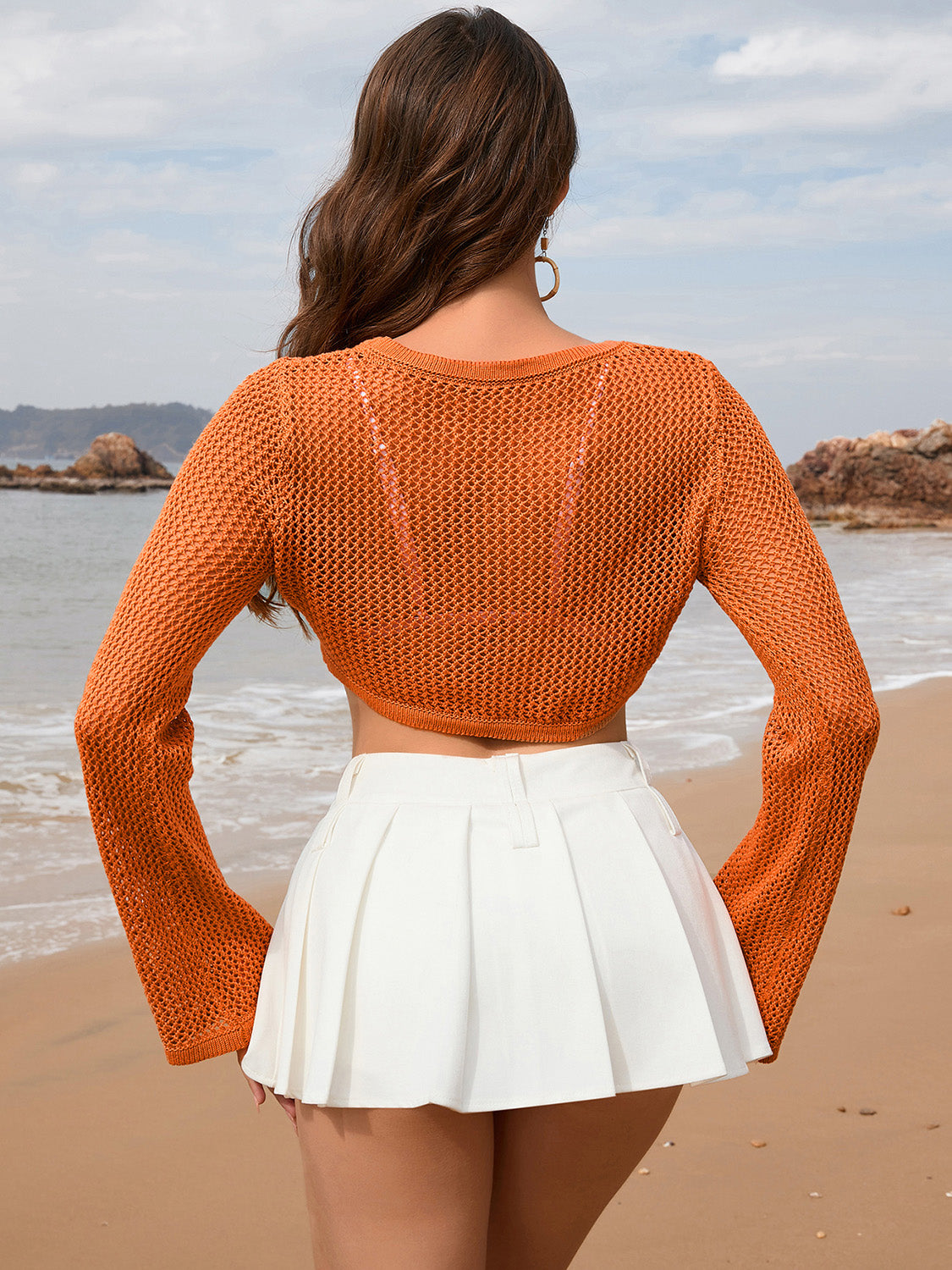 Orange crochet crop top with flared sleeves and open knit detail