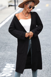 Longline black knit cardigan with pockets and ribbed details.