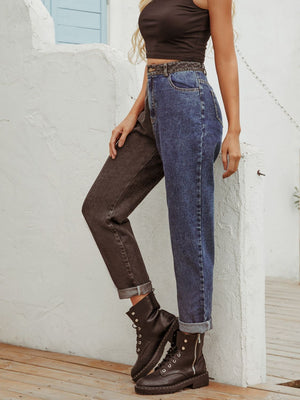 Split-tone straight leg jeans in medium wash denim with contrast dark legs and cuffed hems.