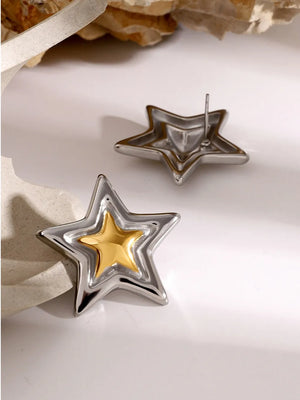 Sculpted starburst stud earrings in silver and gold feature layered star shapes.