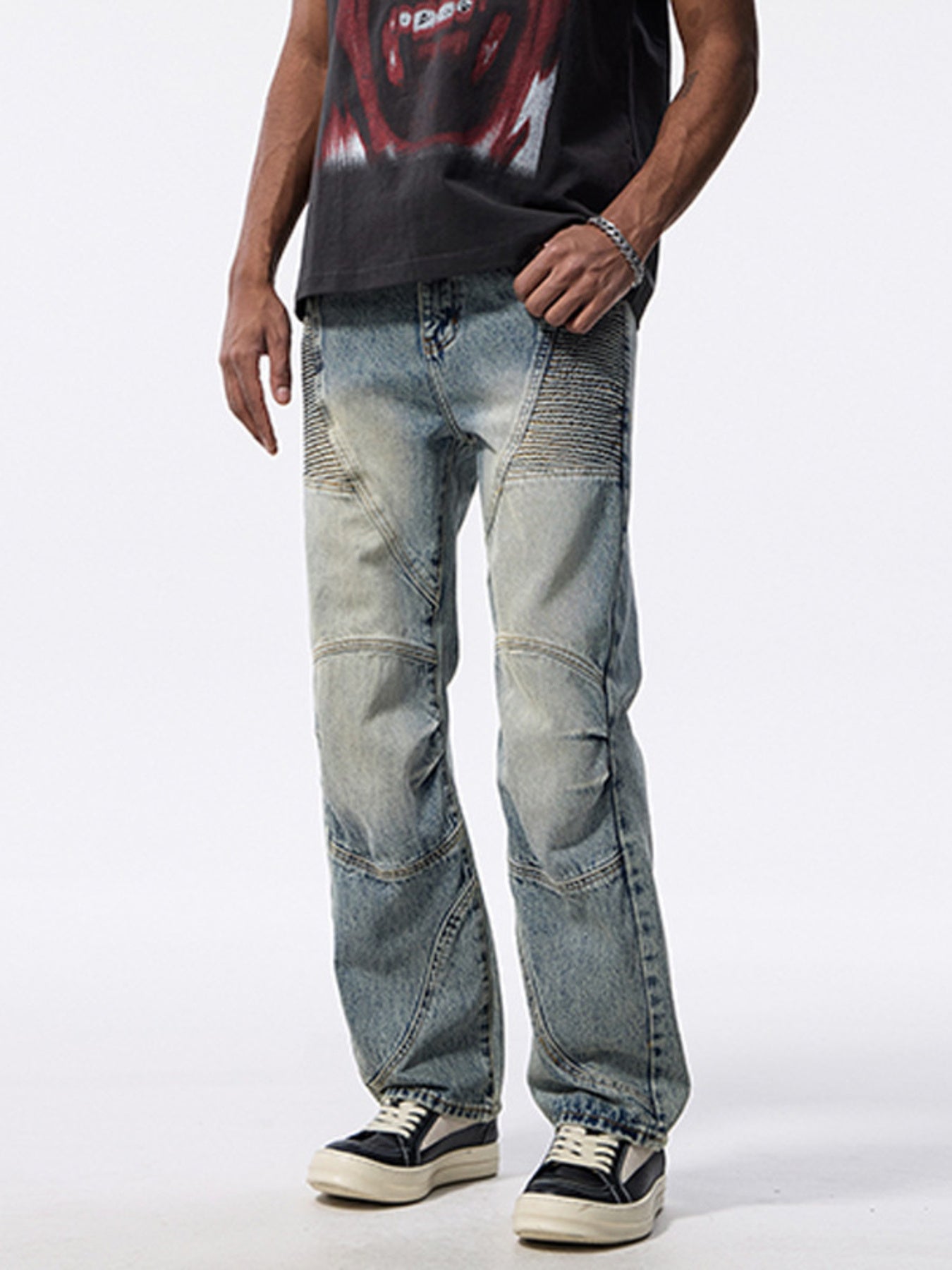 Men's light wash wide-leg jeans with moto-inspired paneling and whiskering detail.
