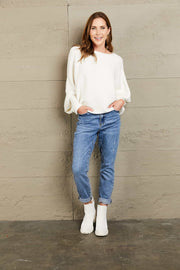 White ribbed dolman knit sweater with boat neck and balloon sleeves.