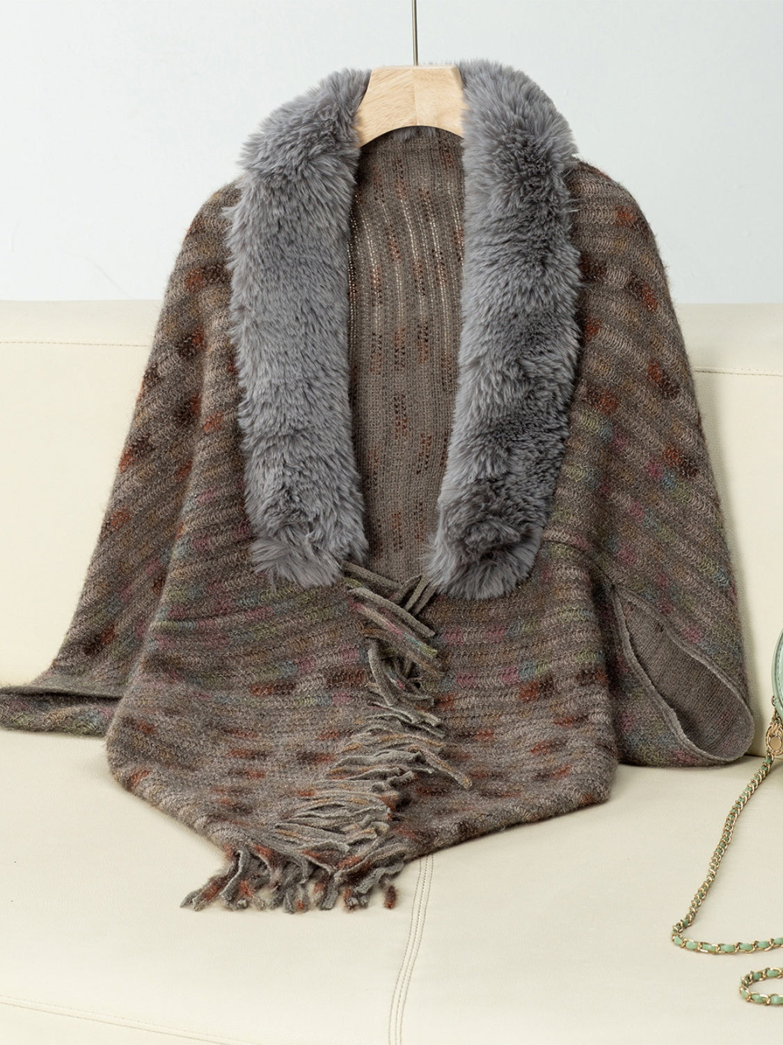 Textured plaid acrylic poncho with faux fur collar and fringe detail in a brown multi-color knit.