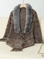 Textured plaid acrylic poncho with faux fur collar and fringe detail in a brown multi-color knit.