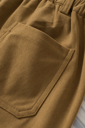 Caramel seamed front wide leg trousers with a visible pocket detail.