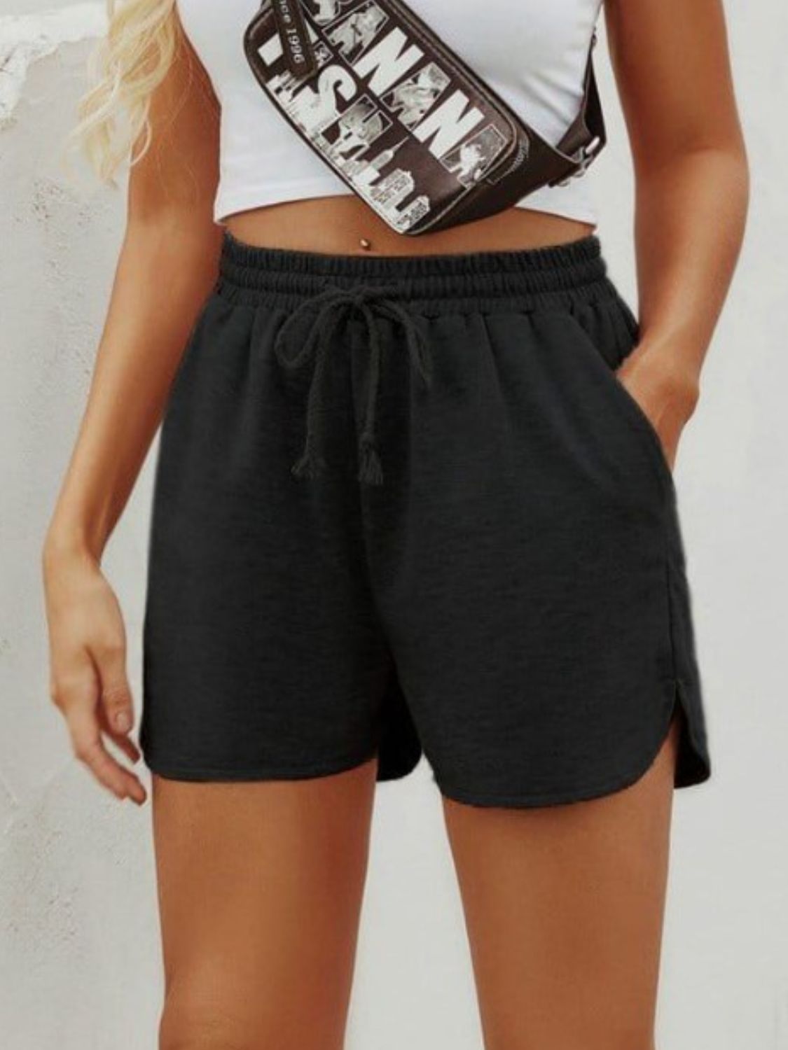 Black textured drawstring shorts with slit hem and pockets